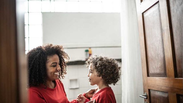 Mother and son in bathroom smiling